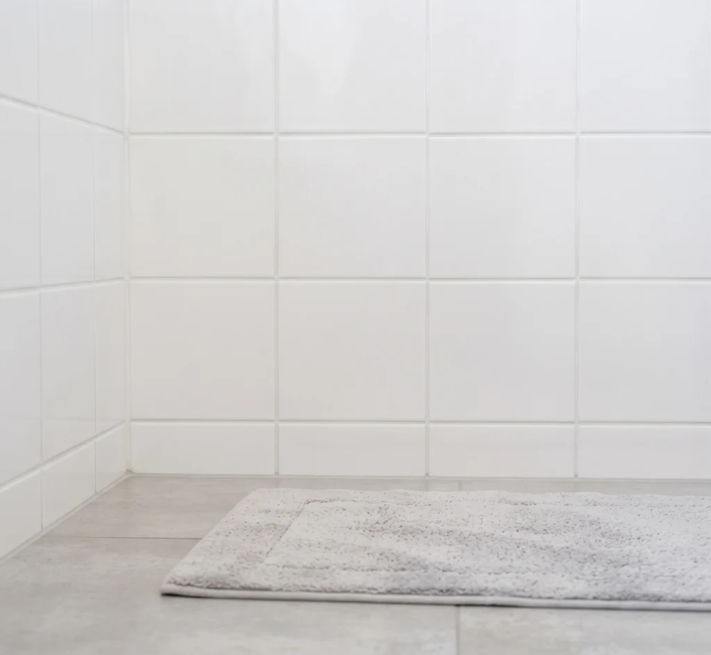 The same bathroom retiled with clean joints and fresh sanitary silicone