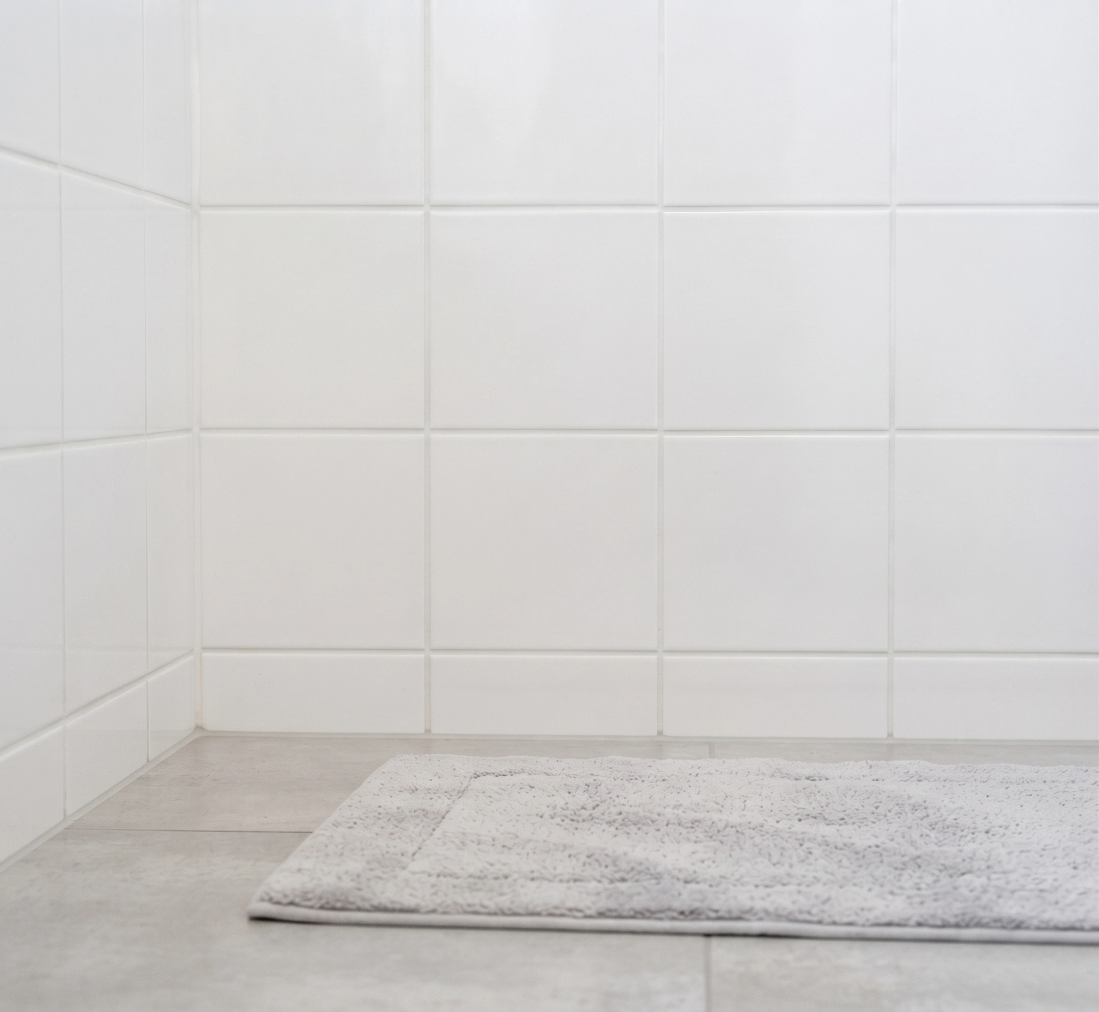 The same bathroom retiled with clean joints and fresh sanitary silicone