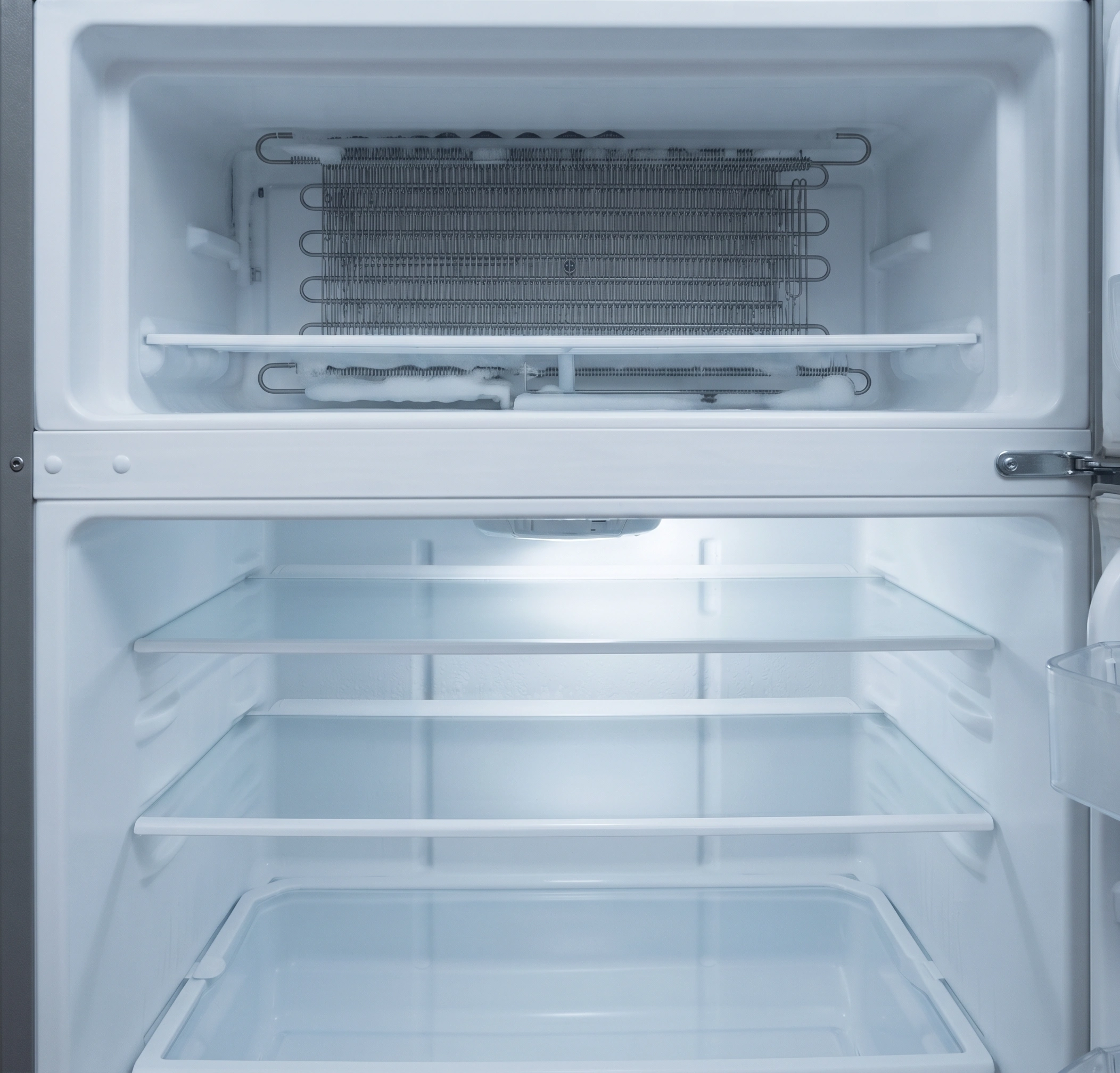 The same fridge clear of ice with the drain cleared and holding temperature