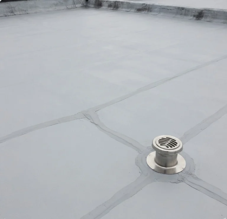 The same roof graded to the outlet and coated, with the ponding gone