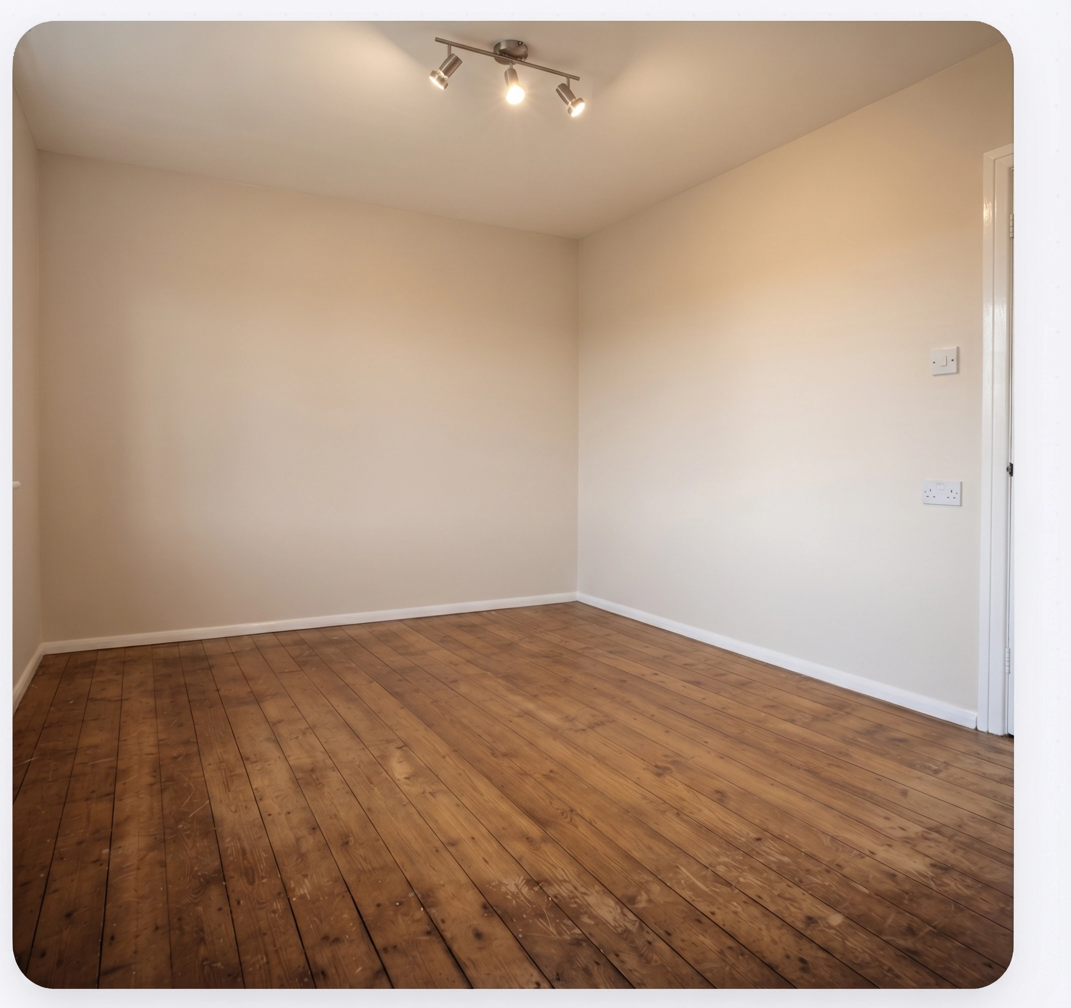 The same room skimmed and painted with new flooring and recessed lighting