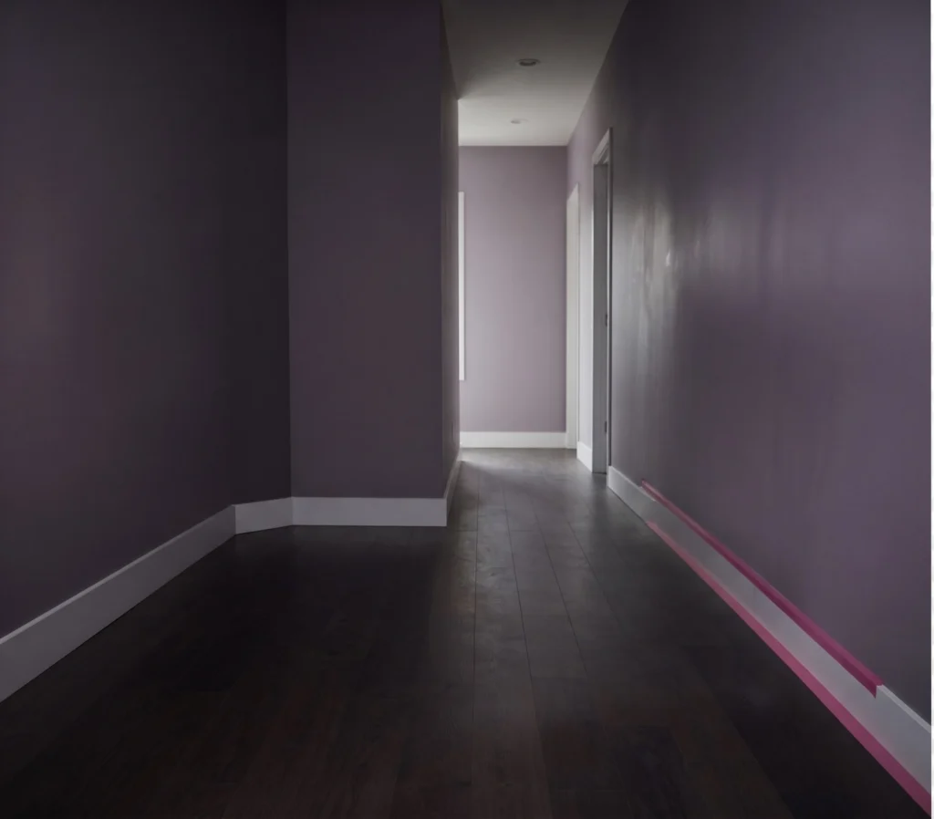 The same hall clear, boxes labelled in the right rooms and the bed rebuilt