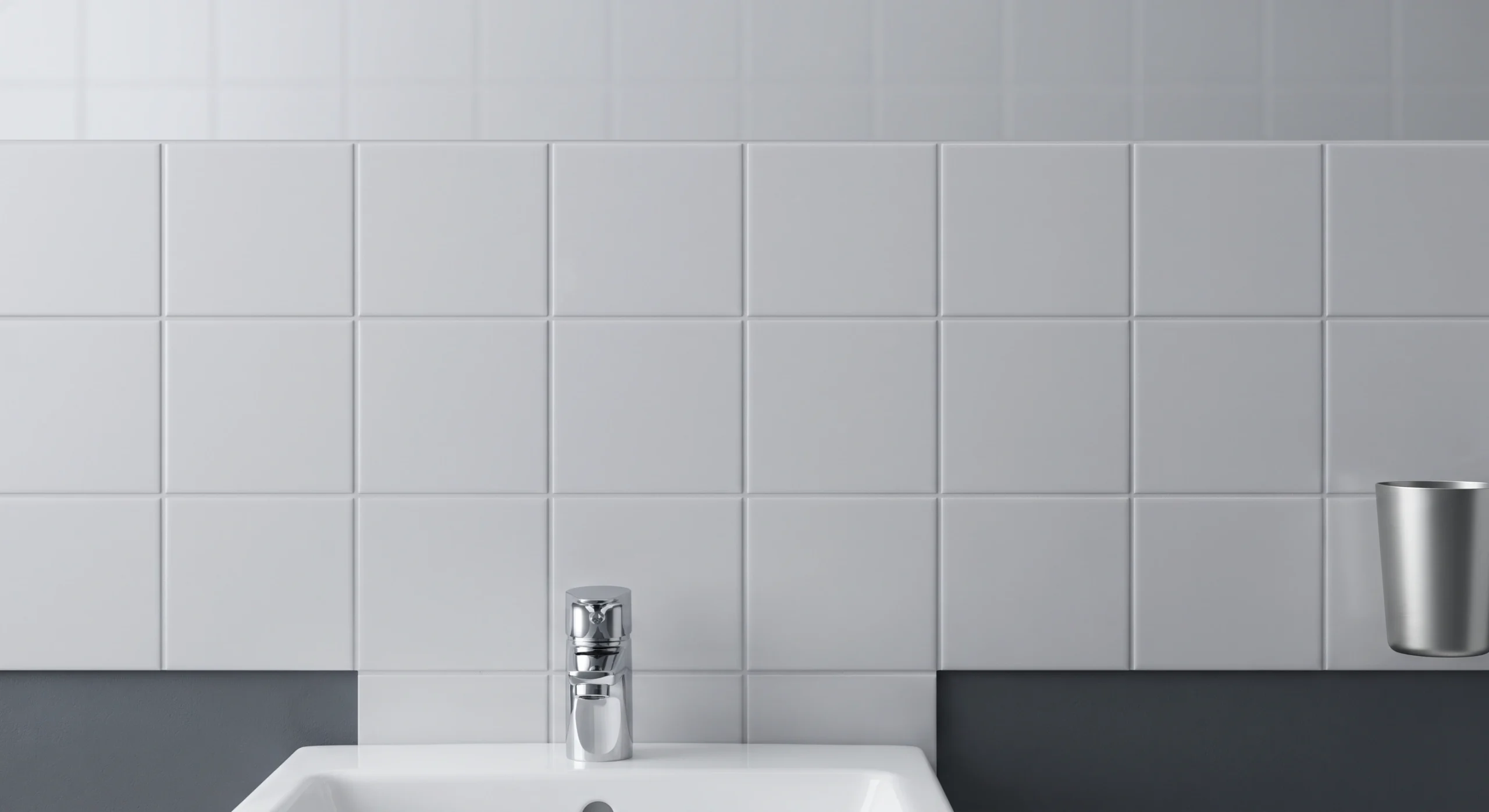 Wall tiling being cut in around fittings in an Islamabad bathroom